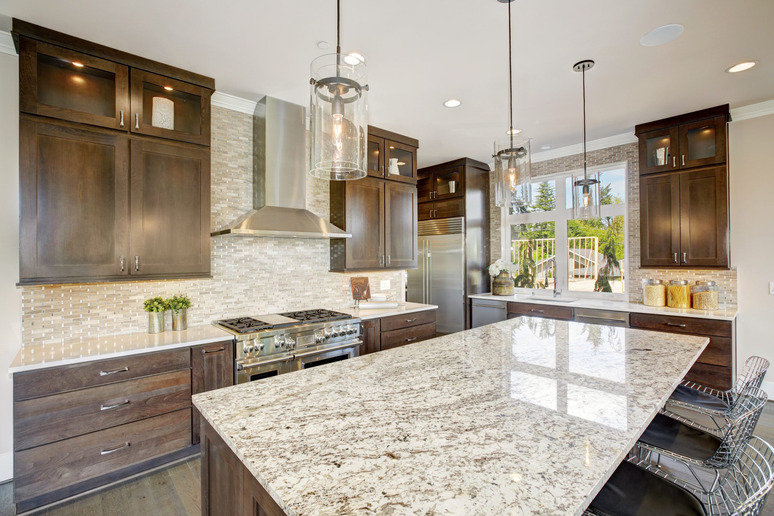 dark wooden custom kitchen cabinets with large island and granite countertops